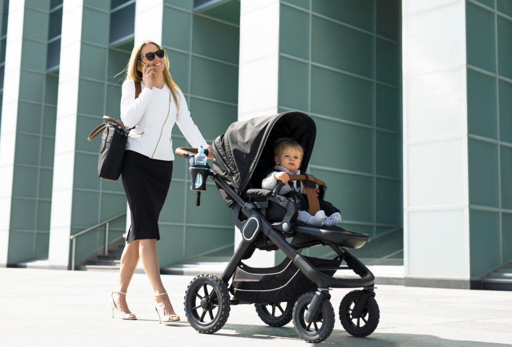 Business,Woman,With,Baby,Carriage,Walking,And,Talking,On,The