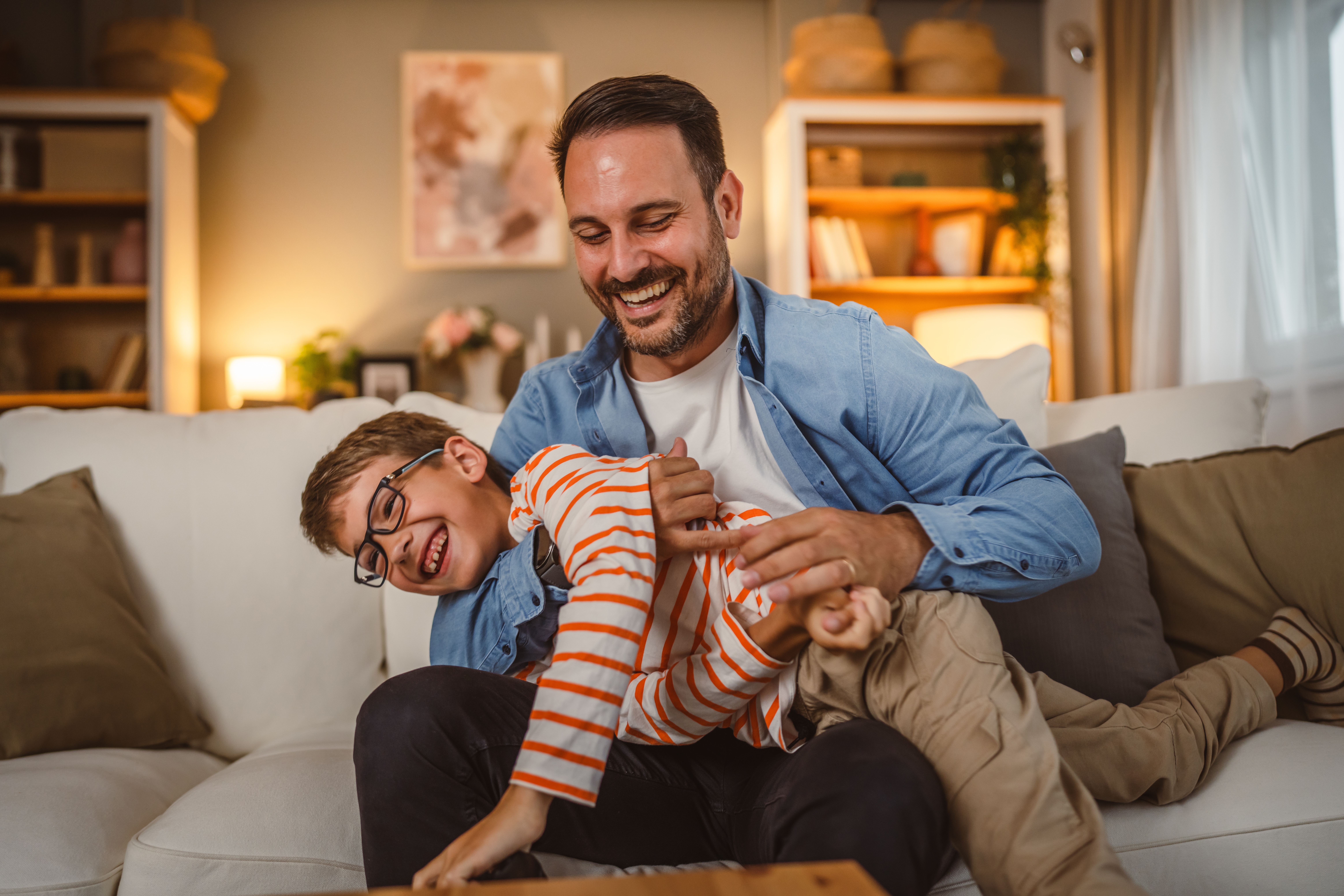 Adult,Caucasian,Father,And,Son,Hug,Each,Other,After,Play