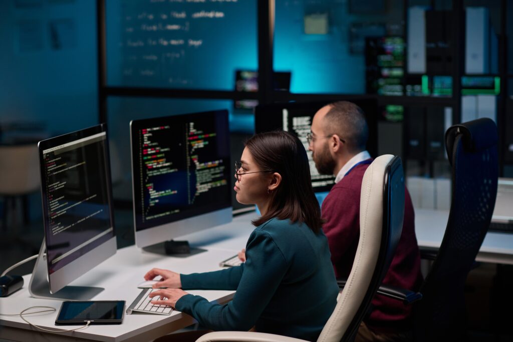 High,Angle,View,At,Two,People,Sitting,At,Workplace,In