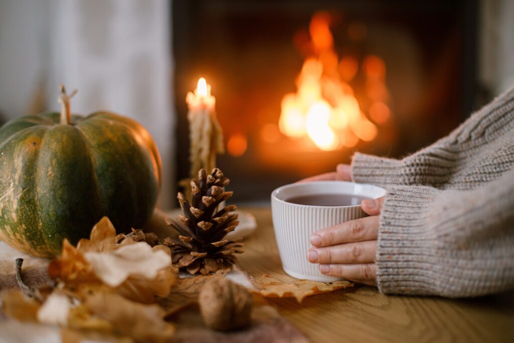 Autumn,Hygge.,Hands,Holding,Cup,Of,Tea,And,Pumpkin,,Autumn
