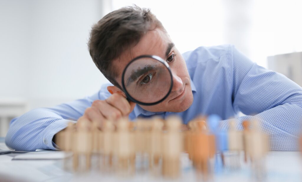 A,Businessman,In,Blue,Shirt,Is,Holding,A,Magnifying,Glass